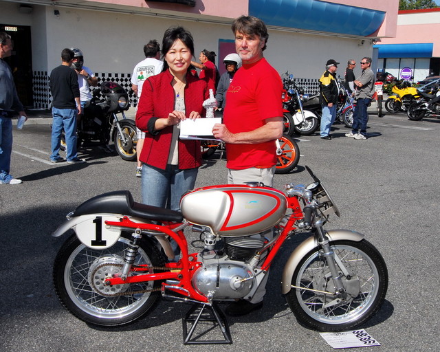 June Lee Owner of Beach Burgers & Robert Bryson with the 1970 Moto Parilla