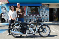 June Lee presenting Larry Horn with the Beach Burger gift certificate and his 1955 Velocette MSS